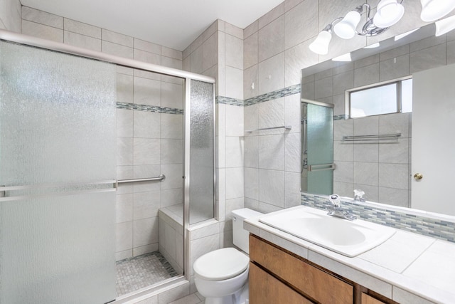 full bathroom with a shower stall, toilet, vanity, and a chandelier