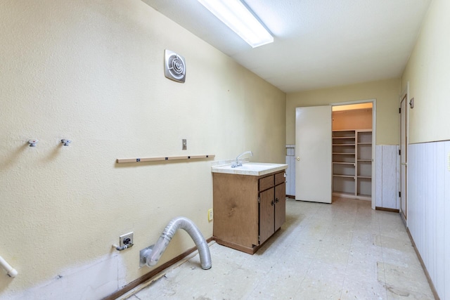 washroom featuring cabinet space and light floors