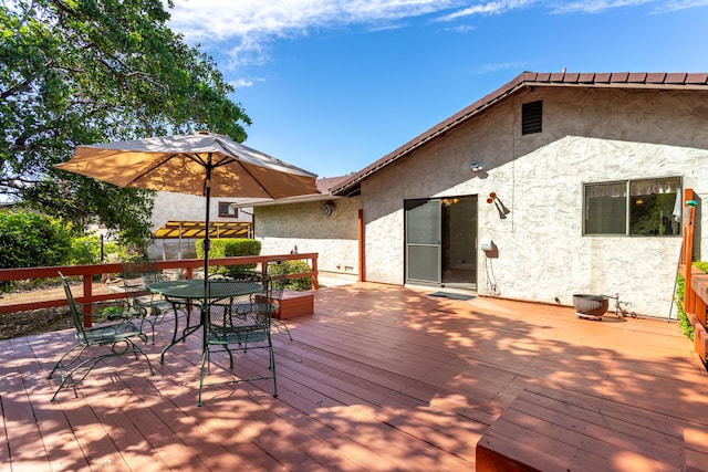 wooden deck featuring outdoor dining space