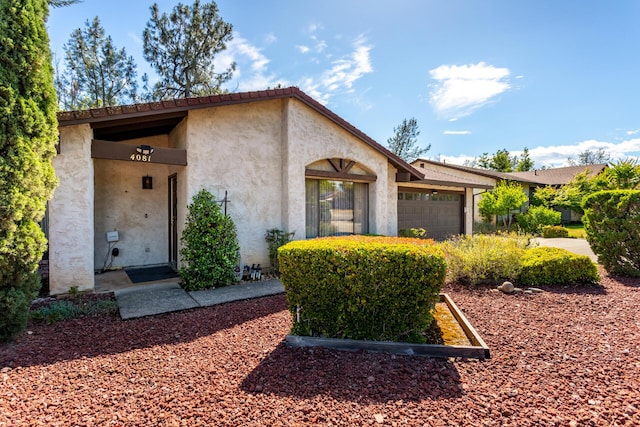 view of front of property featuring a garage and stucco siding