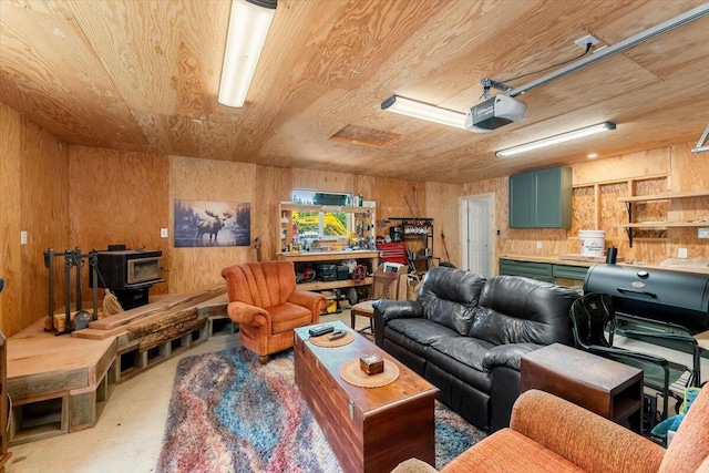 2125 Lava, Mccloud, CA 96057 - living area with wooden ceiling, a wood stove, wooden walls, and finished concrete flooring