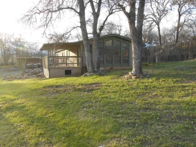 1090 Crooked Oak Ln, Redding, CA 96003 - back of property featuring a sunroom, a yard, and a wooden deck