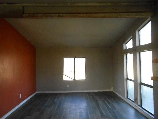 1090 Crooked Oak Ln, Redding, CA 96003 - spare room featuring vaulted ceiling, dark wood-style flooring, and baseboards