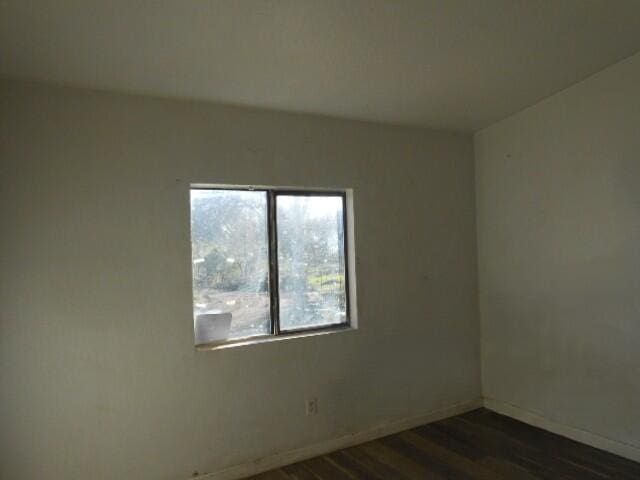 1090 Crooked Oak Ln, Redding, CA 96003 - empty room with dark wood-style flooring and baseboards