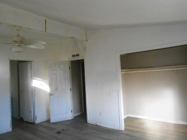 1090 Crooked Oak Ln, Redding, CA 96003 - unfurnished bedroom with wood finished floors, a closet, and baseboards
