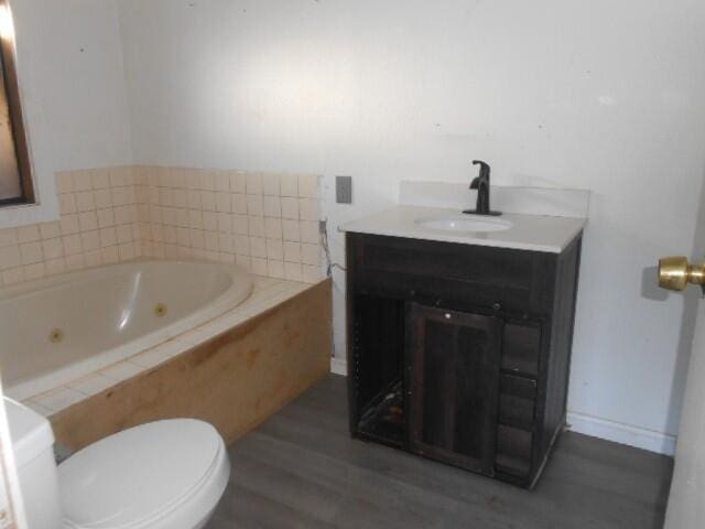 1090 Crooked Oak Ln, Redding, CA 96003 - full bathroom with toilet, wood finished floors, vanity, and a jetted tub