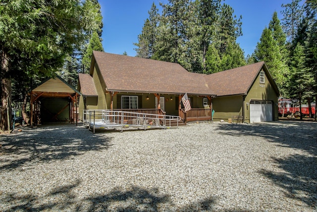 7289 Clarabelle Ln, Shingletown, CA 96088 - rustic home featuring a porch, a garage, driveway, and roof with shingles