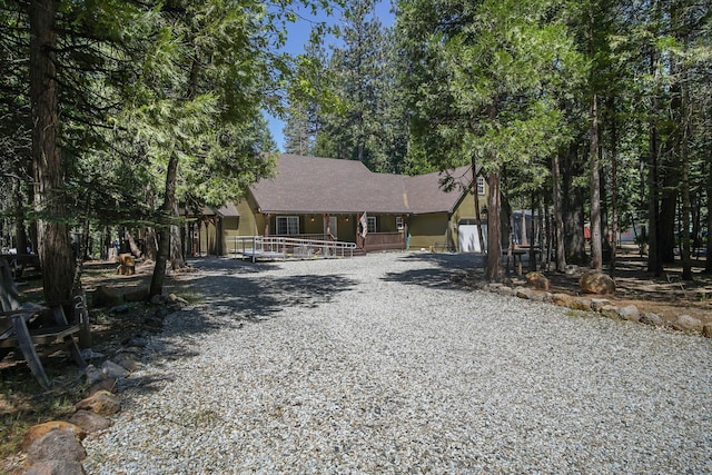 7289 Clarabelle Ln, Shingletown, CA 96088 - view of front of home featuring a porch, a garage, and driveway