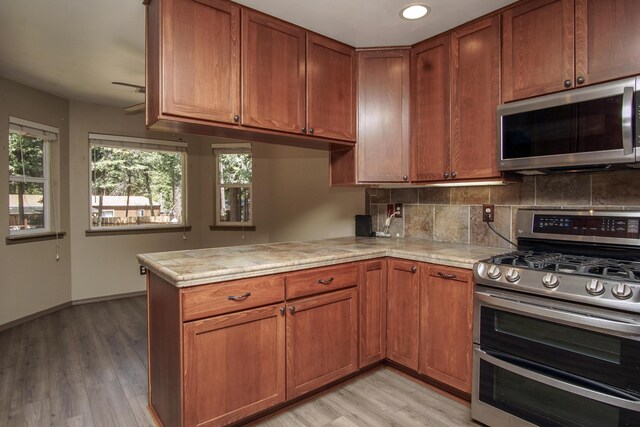 7289 Clarabelle Ln, Shingletown, CA 96088 - kitchen featuring stainless steel appliances, light countertops, backsplash, plenty of natural light, and recessed lighting