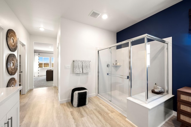 4148 Haleakala Ave, Redding, CA 96001 - bathroom featuring wood finished floors, vanity, a stall shower, and baseboards
