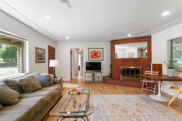 2722 Russell St, Redding, CA 96001 - living room featuring light wood-style floors, recessed lighting, and a fireplace