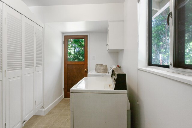 2722 Russell St, Redding, CA 96001 - laundry area featuring cabinet space, light tile patterned floors, washing machine and clothes dryer, and baseboards