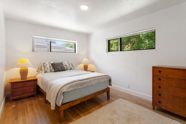2722 Russell St, Redding, CA 96001 - bedroom with multiple windows, baseboards, and light wood finished floors