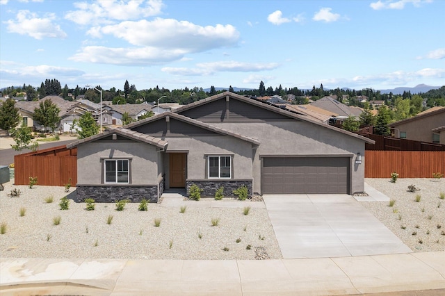 903 Katmai Pl, Redding, CA 96001 - view of front of house featuring stucco siding, a garage, fence, stone siding, and driveway