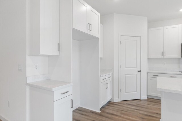 903 Katmai Pl, Redding, CA 96001 - kitchen with light wood-type flooring, light countertops, white cabinets, baseboards, and recessed lighting
