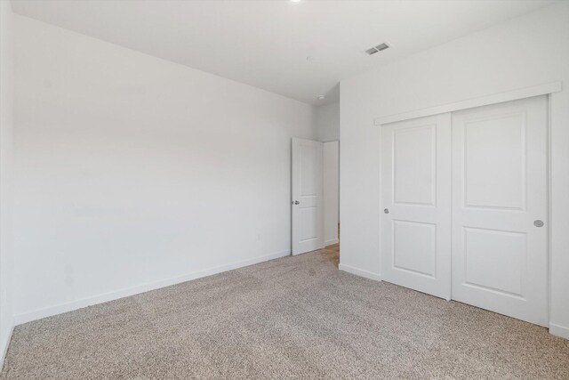 903 Katmai Pl, Redding, CA 96001 - unfurnished bedroom featuring light colored carpet, a closet, and baseboards