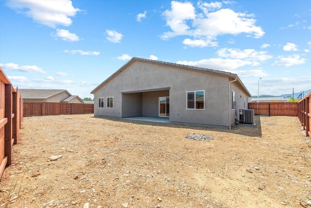 903 Katmai Pl, Redding, CA 96001 - rear view of property featuring a fenced backyard, stucco siding, cooling unit, and a patio