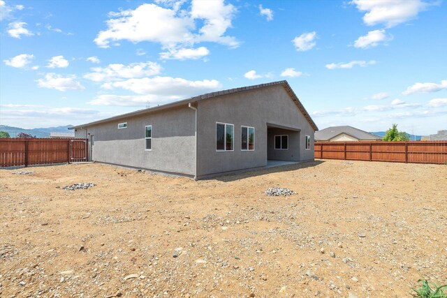 903 Katmai Pl, Redding, CA 96001 - rear view of house featuring stucco siding and a fenced backyard
