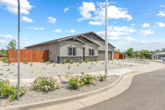 903 Katmai Pl, Redding, CA 96001 - view of front of house with stucco siding, fence, a garage, and stone siding