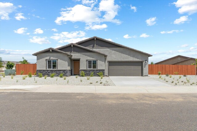 903 Katmai Pl, Redding, CA 96001 - view of front of home featuring fence, stone siding, an attached garage, and stucco siding