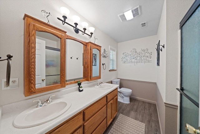 37189 Galena Cir, Burney, CA 96013 - bathroom with wood finished floors, double vanity, toilet, and a shower