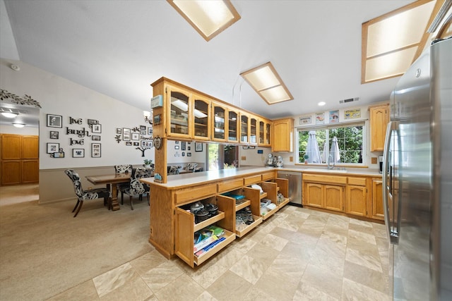 37189 Galena Cir, Burney, CA 96013 - kitchen with appliances with stainless steel finishes, a sink, light countertops, glass insert cabinets, and vaulted ceiling