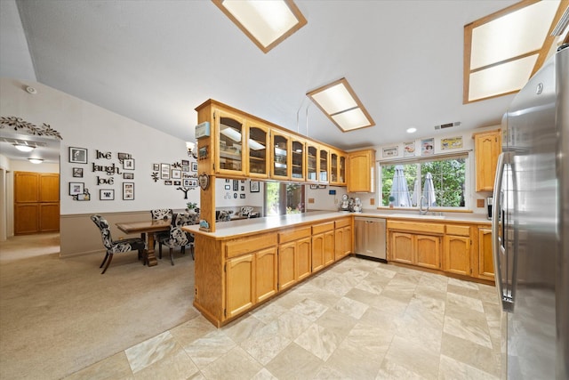 37189 Galena Cir, Burney, CA 96013 - kitchen with appliances with stainless steel finishes, vaulted ceiling, light countertops, a peninsula, and glass insert cabinets