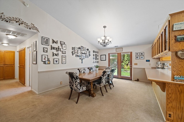 37189 Galena Cir, Burney, CA 96013 - dining area featuring light carpet, a chandelier, baseboards, and vaulted ceiling
