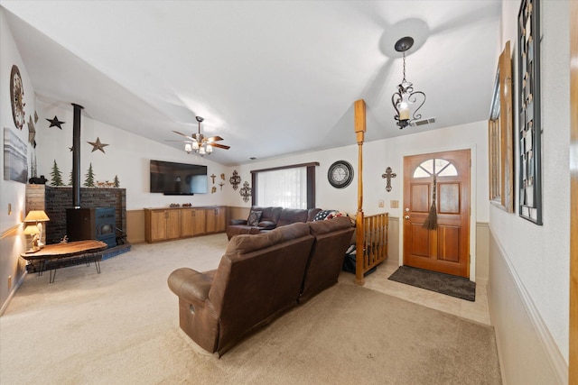 37189 Galena Cir, Burney, CA 96013 - living area with vaulted ceiling, light colored carpet, a wood stove, and ceiling fan