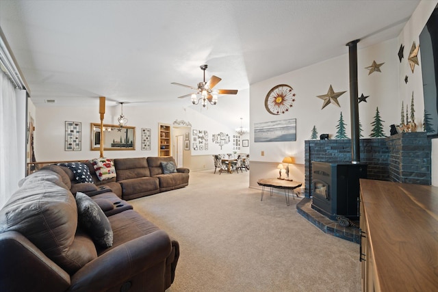 37189 Galena Cir, Burney, CA 96013 - living room with carpet flooring, ceiling fan, a wood stove, and vaulted ceiling
