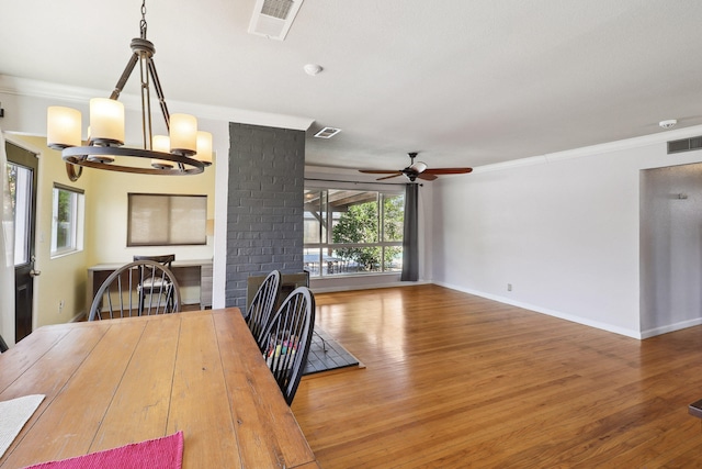 5801 Mountain View Dr, Redding, CA 96003 - dining area featuring a chandelier, ceiling fan, crown molding, wood finished floors, and baseboards