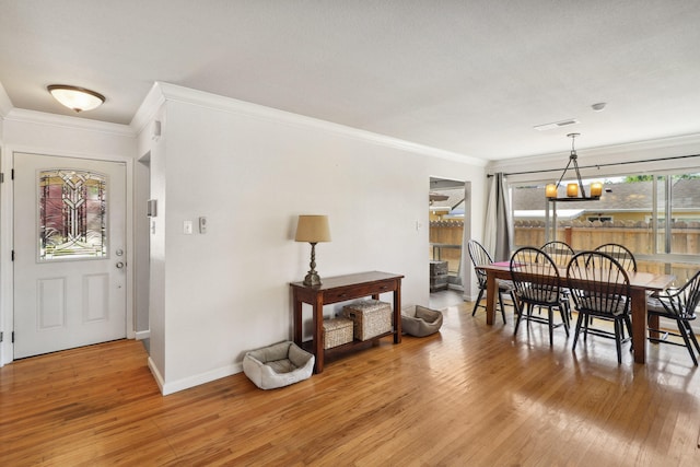 5801 Mountain View Dr, Redding, CA 96003 - dining area featuring crown molding, light wood finished floors, baseboards, and a chandelier