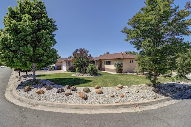 5801 Mountain View Dr, Redding, CA 96003 - view of front of home featuring stucco siding, a front lawn, a garage, and driveway
