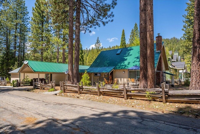 38290 Battle Creek Ave, Mineral, CA 96063 - view of front of home with metal roof, a garage, driveway, and a chimney