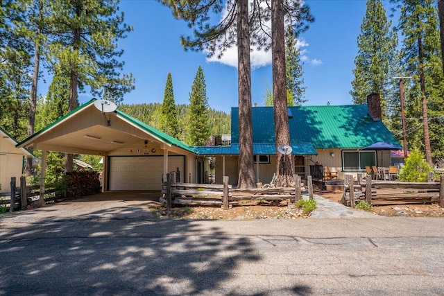 38290 Battle Creek Ave, Mineral, CA 96063 - view of front facade featuring a chimney, metal roof, asphalt driveway, and a garage
