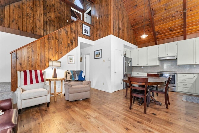 38290 Battle Creek Ave, Mineral, CA 96063 - dining area featuring high vaulted ceiling, light wood finished floors, wooden ceiling with exposed beams, baseboards, and stairway