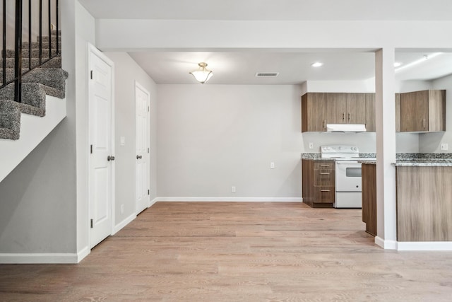 628 Hartnell Ave, Redding, CA 96002 - kitchen with electric stove, light wood-style flooring, baseboards, brown cabinetry, and recessed lighting
