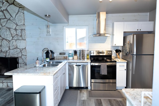 1018 Pineland Dr, Redding, CA 96002 - kitchen with stainless steel appliances, wall chimney exhaust hood, a sink, dark wood-type flooring, and white cabinets