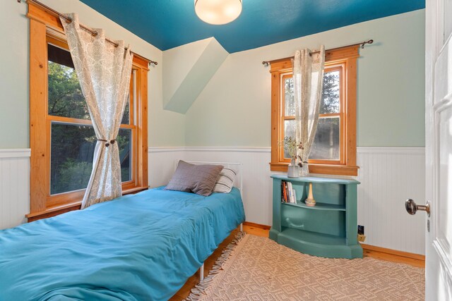 7704 Eastmoore Rd, Shingletown, CA 96088 - bedroom with a wainscoted wall, wood finished floors, and multiple windows