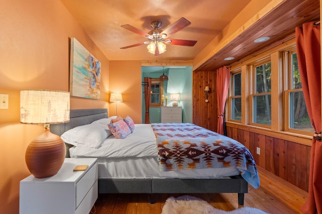 7704 Eastmoore Rd, Shingletown, CA 96088 - bedroom with hardwood / wood-style flooring, wooden walls, and ceiling fan