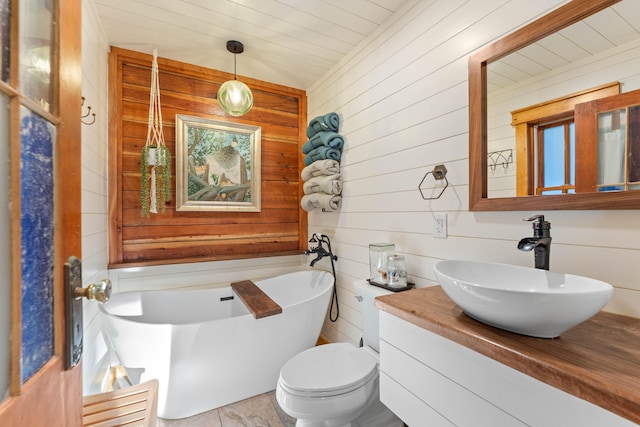 7704 Eastmoore Rd, Shingletown, CA 96088 - full bathroom with wooden walls, a soaking tub, vanity, and toilet