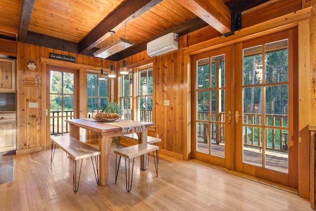 7704 Eastmoore Rd, Shingletown, CA 96088 - dining space featuring beamed ceiling, french doors, wood walls, an AC wall unit, and light wood-type flooring