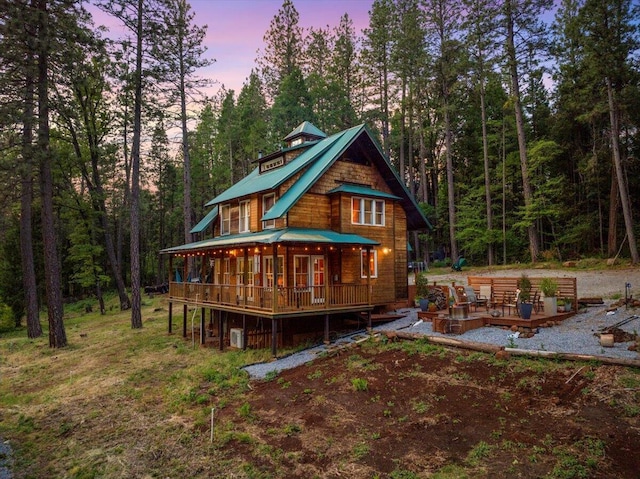 7704 Eastmoore Rd, Shingletown, CA 96088 - back of house at dusk featuring a wooden deck