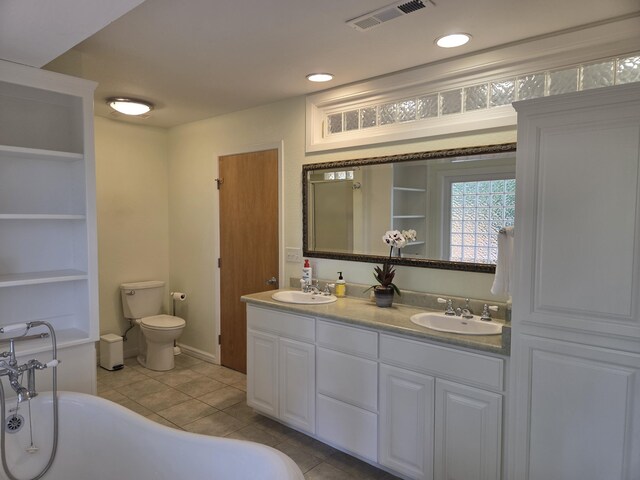 8198 Green Acres Ln, Redding, CA 96002 - bathroom with tile patterned flooring, double vanity, a freestanding tub, toilet, and built in features