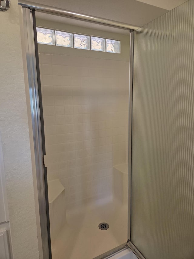 8198 Green Acres Ln, Redding, CA 96002 - full bath with plenty of natural light, a shower stall, and a textured wall