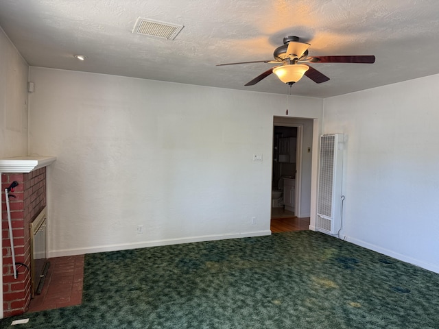 1434 Jeffries Ave, Anderson, CA 96007 - spare room with a heating unit, a ceiling fan, carpet, and a brick fireplace