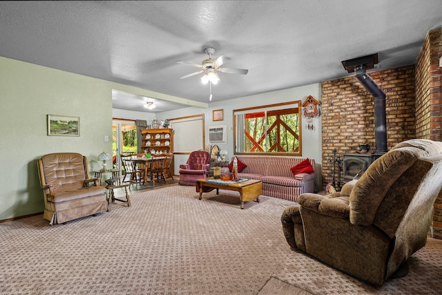 7372 Tahoe Ln, Shingletown, CA 96088 - living room featuring carpet flooring, a wood stove, ceiling fan, a textured ceiling, and a wall mounted air conditioner