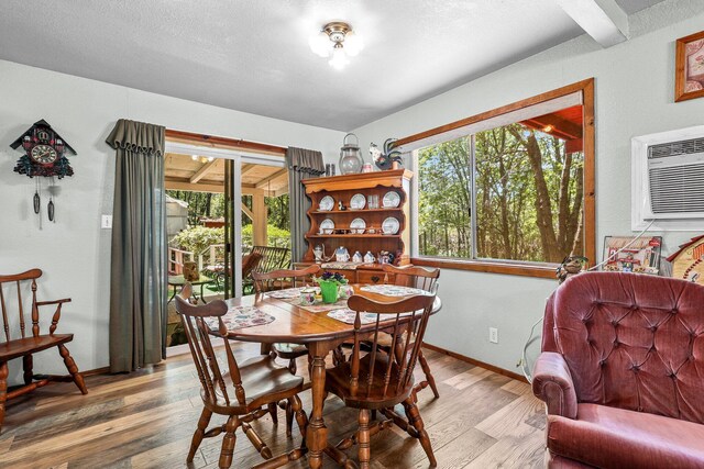 7372 Tahoe Ln, Shingletown, CA 96088 - dining area featuring wood finished floors, baseboards, and an AC wall unit