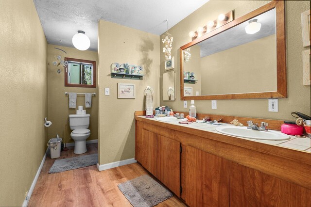 7372 Tahoe Ln, Shingletown, CA 96088 - full bath with wood finished floors, double vanity, toilet, and baseboards