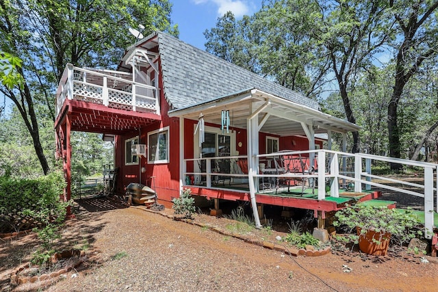 7372 Tahoe Ln, Shingletown, CA 96088 - view of front facade featuring roof with shingles and a wooden deck